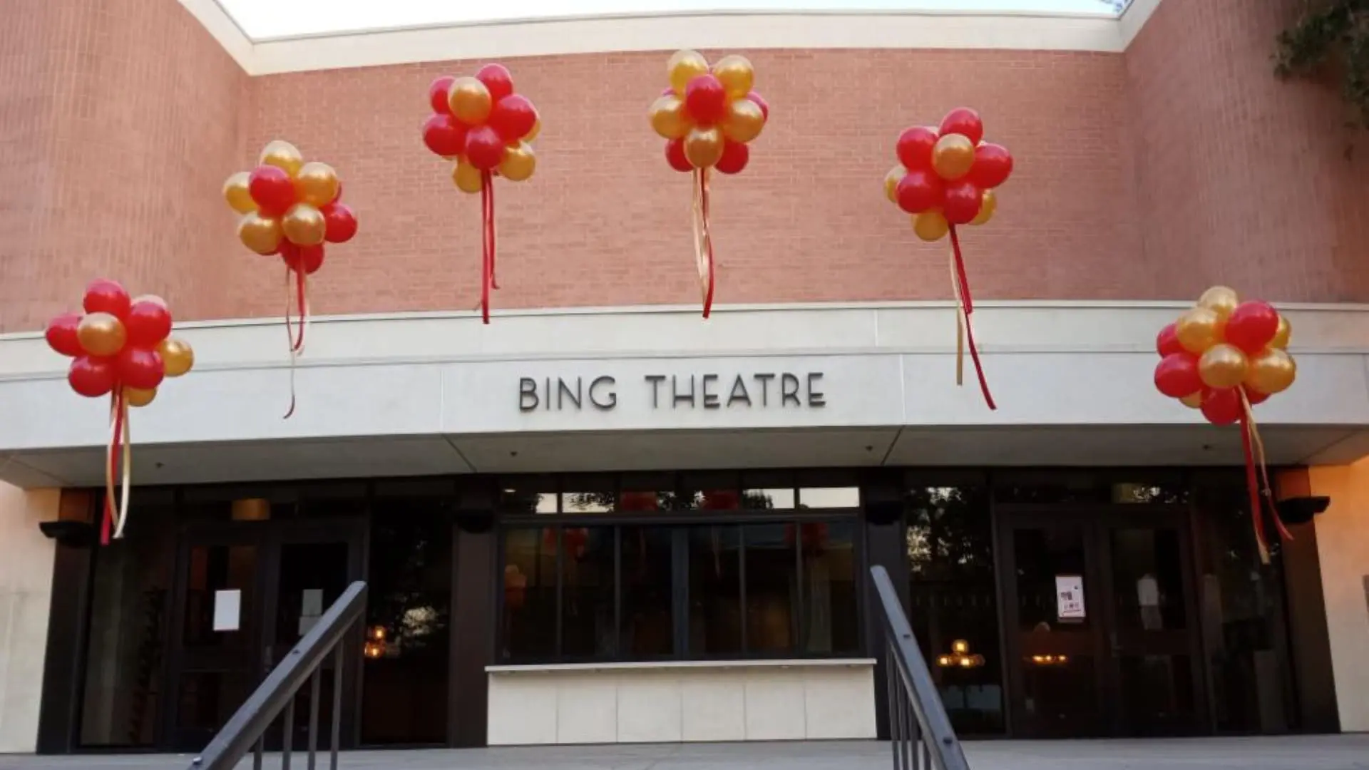 Bing Theatre entrance with red and gold balloons