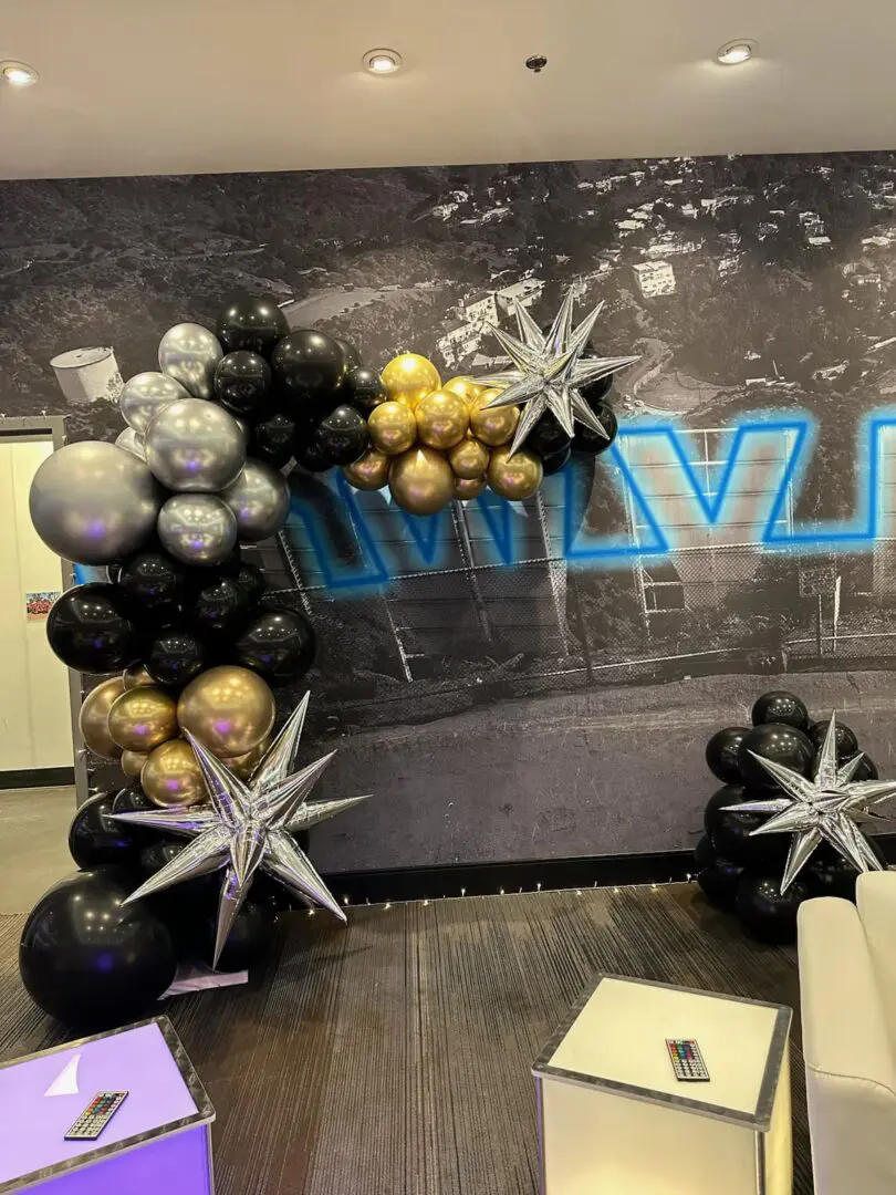 Black, gold, and silver balloon arch with stars