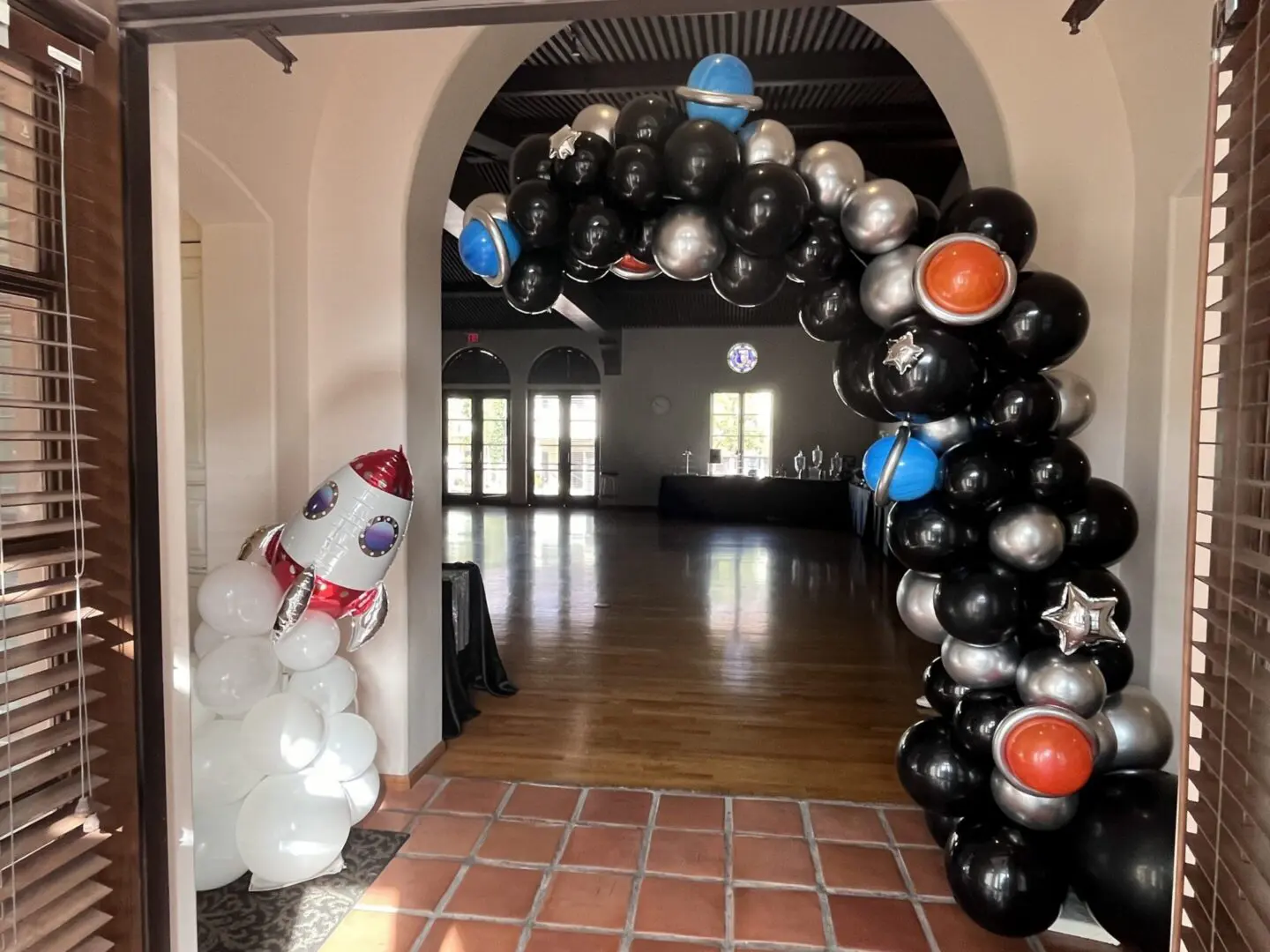 Space-themed balloon arch with rocket