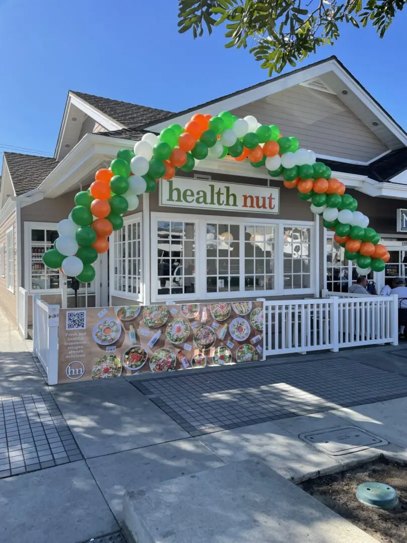 Health Nut storefront with green-white-orange balloons