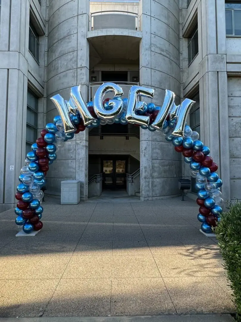 Silver letter balloon arch spelling MGEN