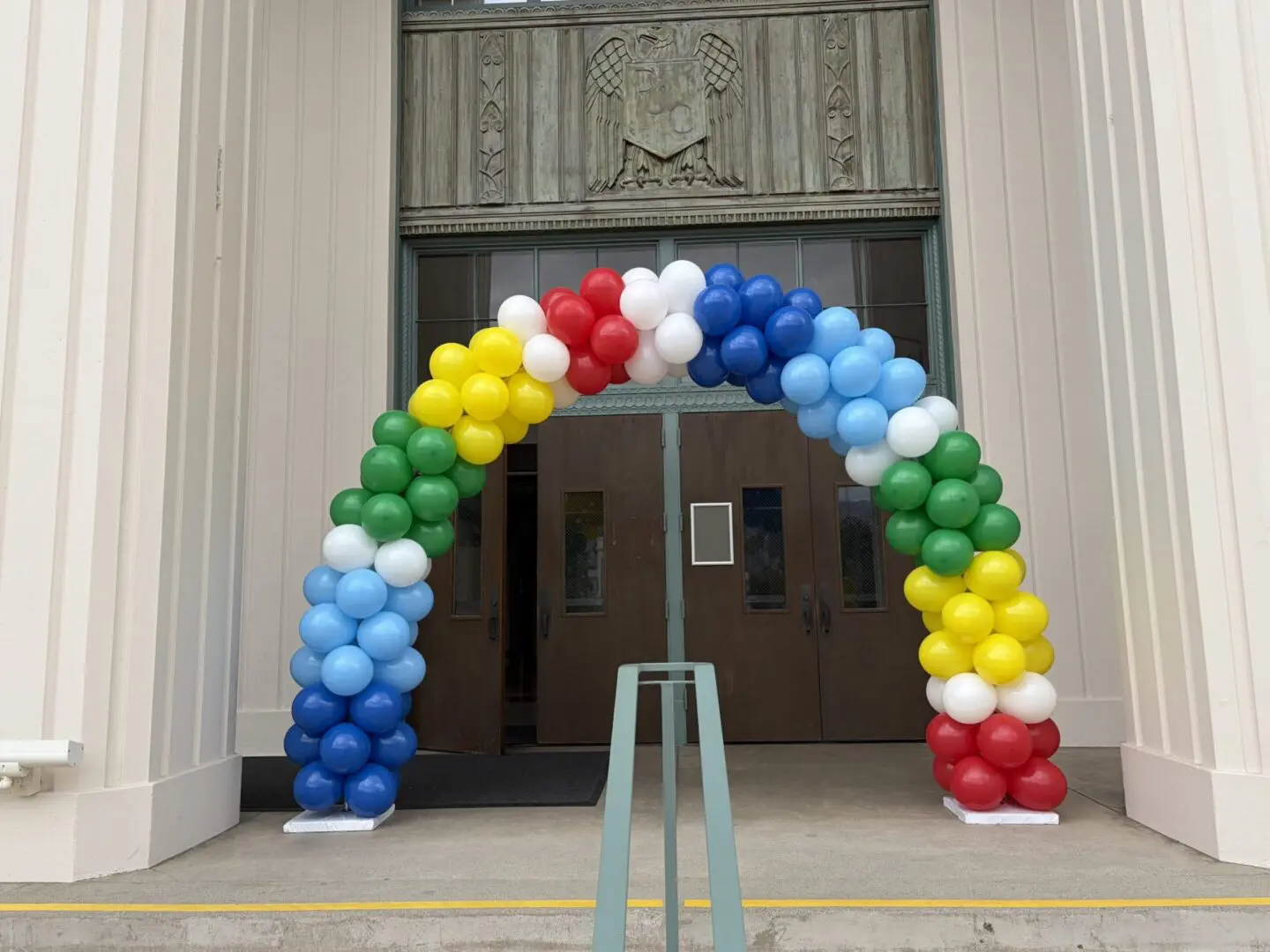 Colorful balloon arch at building entrance
