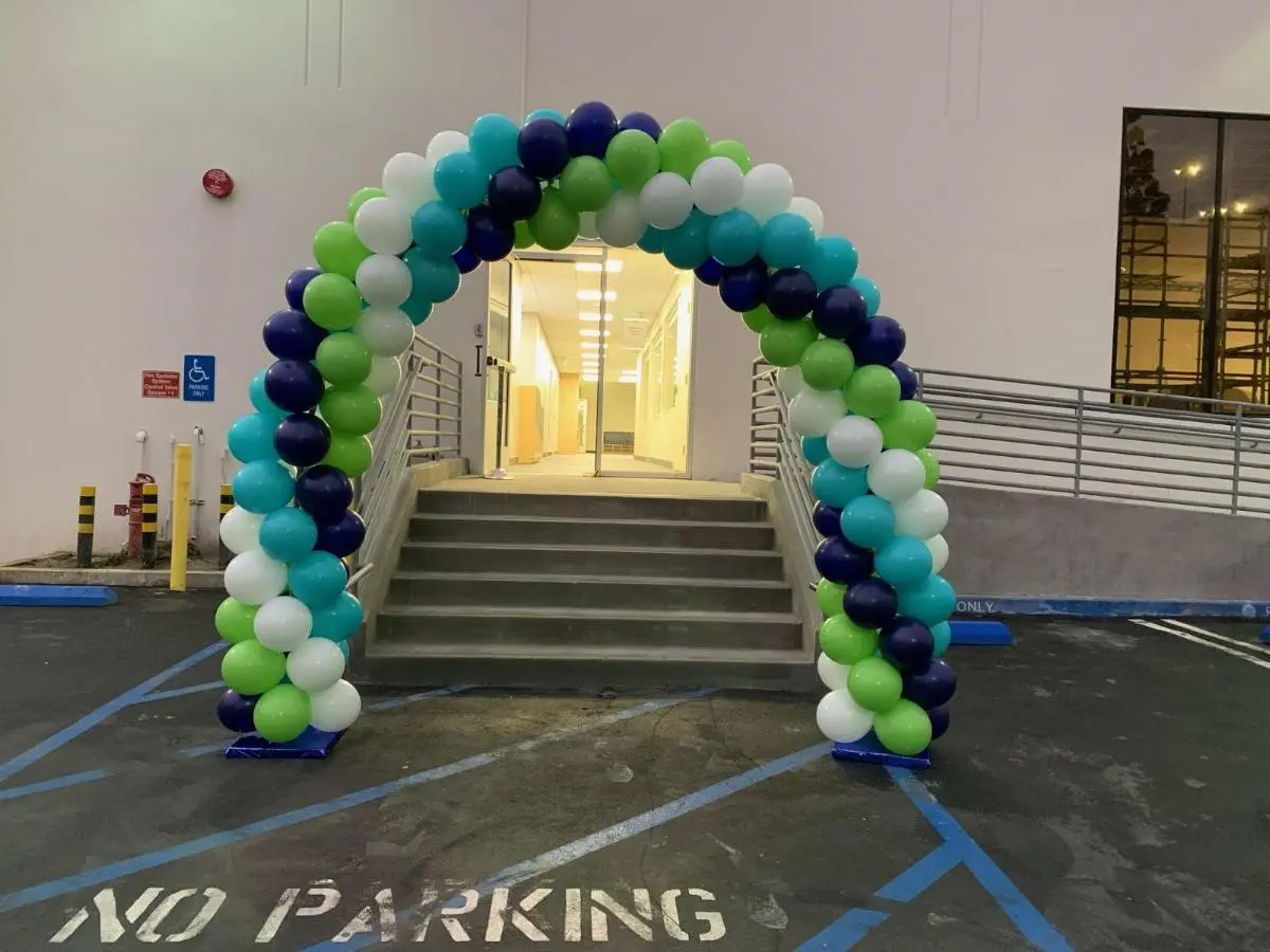 Colorful balloon arch at building entrance