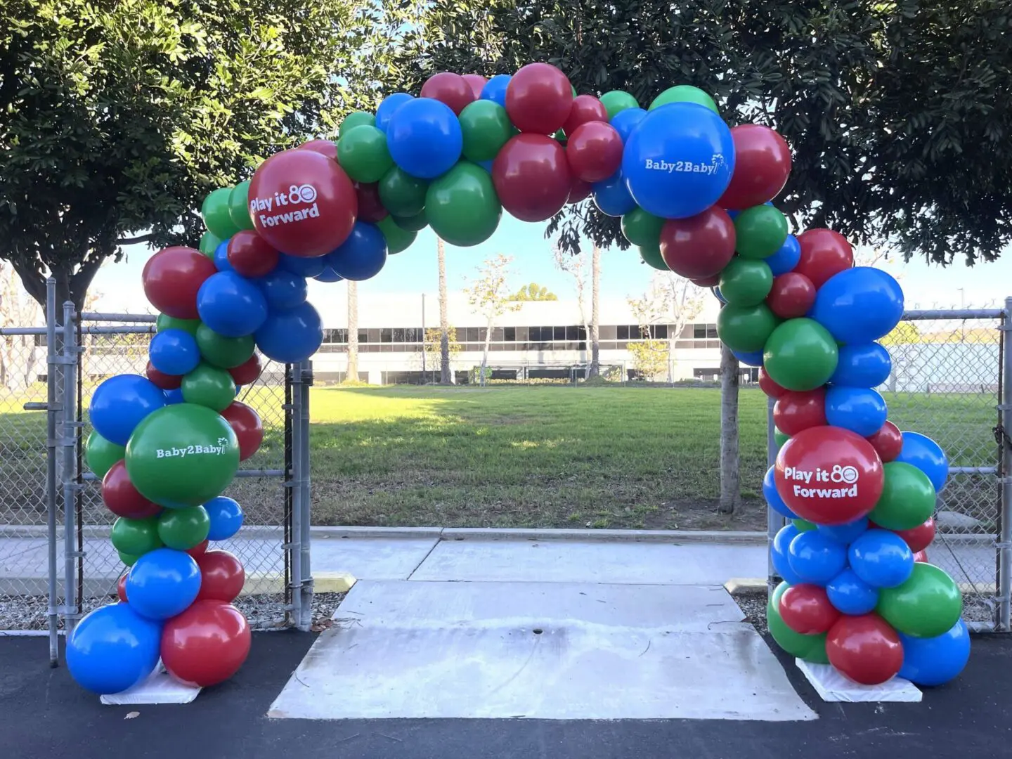 Outdoor red, blue, green balloon arch entrance
