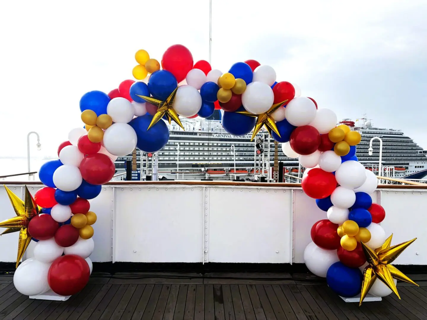 Red white blue balloon arch with gold stars