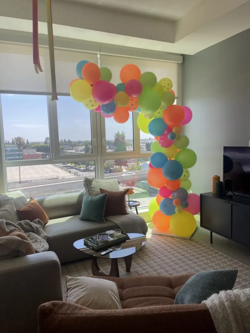 Colorful balloon arch decorating bright living room