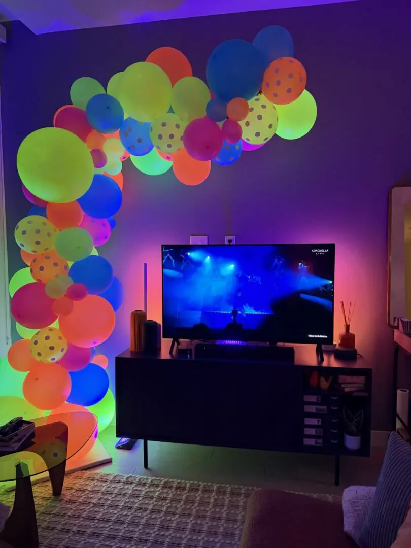Colorful neon balloon arch around TV