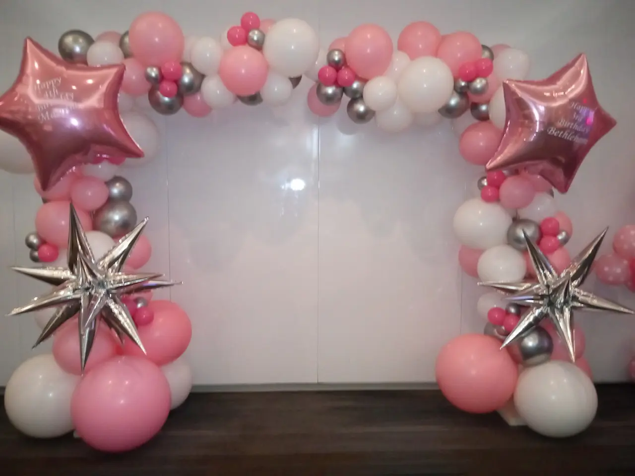 Pink and silver balloon arch with stars