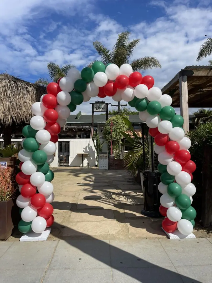Red white green balloon arch at entrance