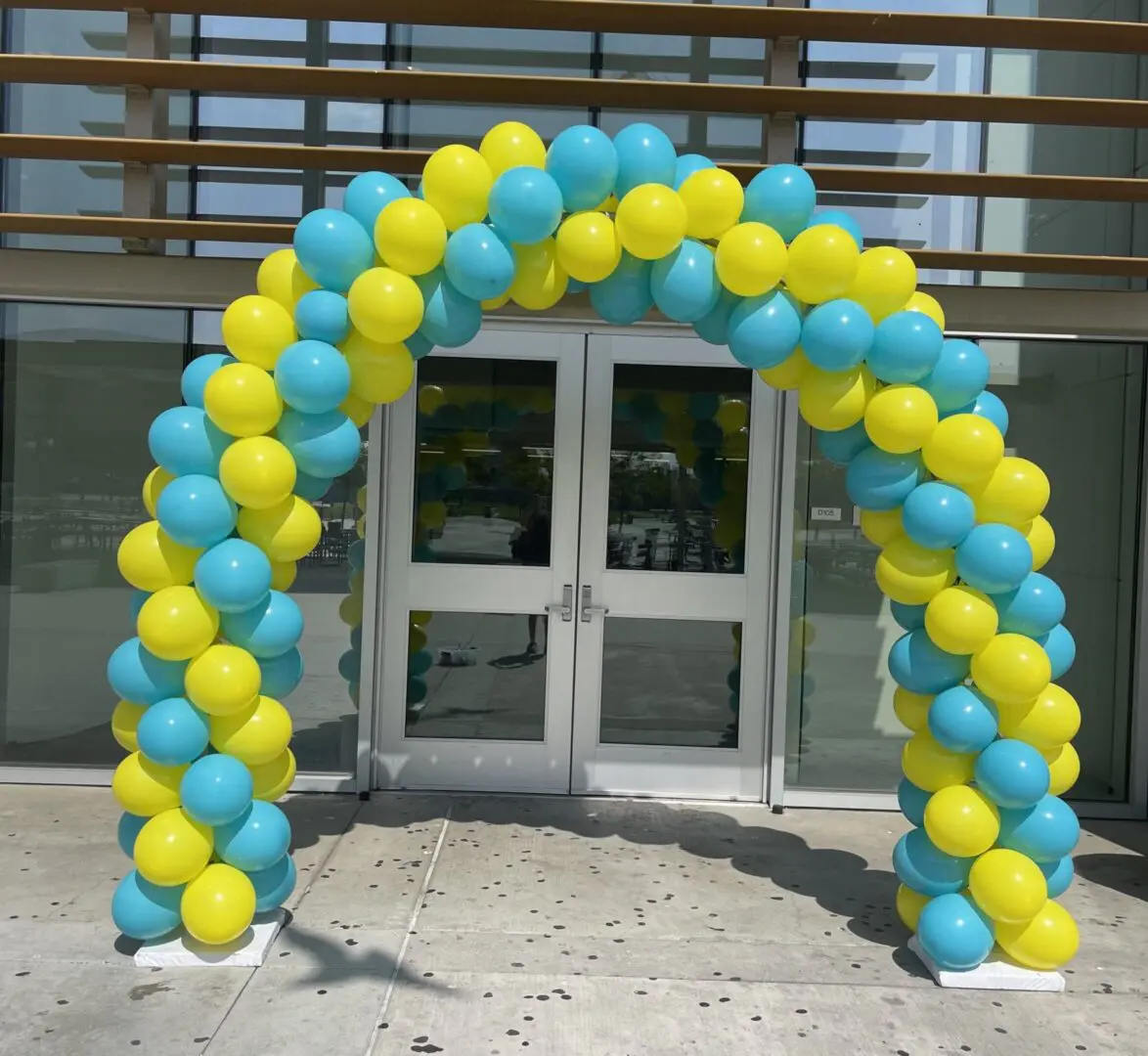 Blue and yellow balloon arch at entrance