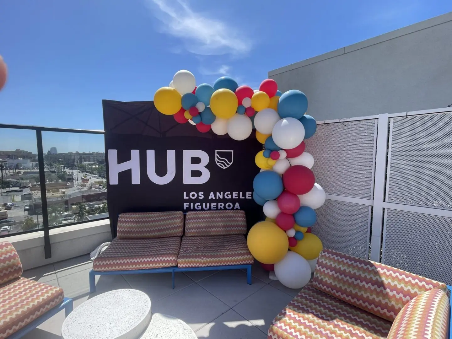 Rooftop lounge with HUB sign and colorful balloons
