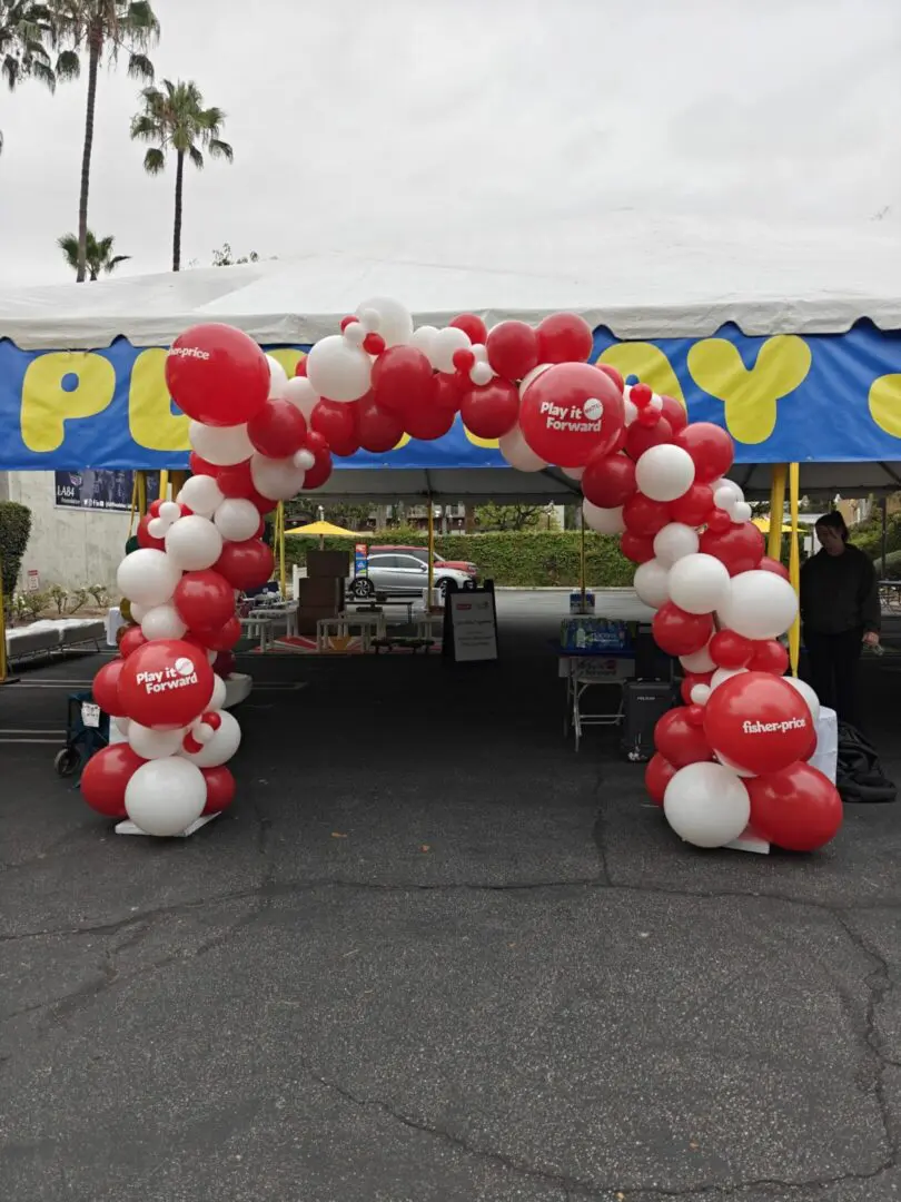 Red and white balloon arch at event