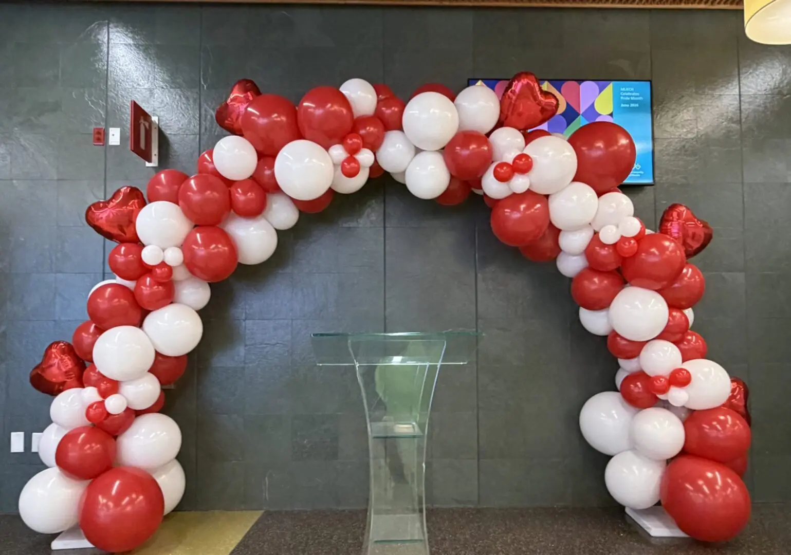 Red and white heart-shaped balloon arch