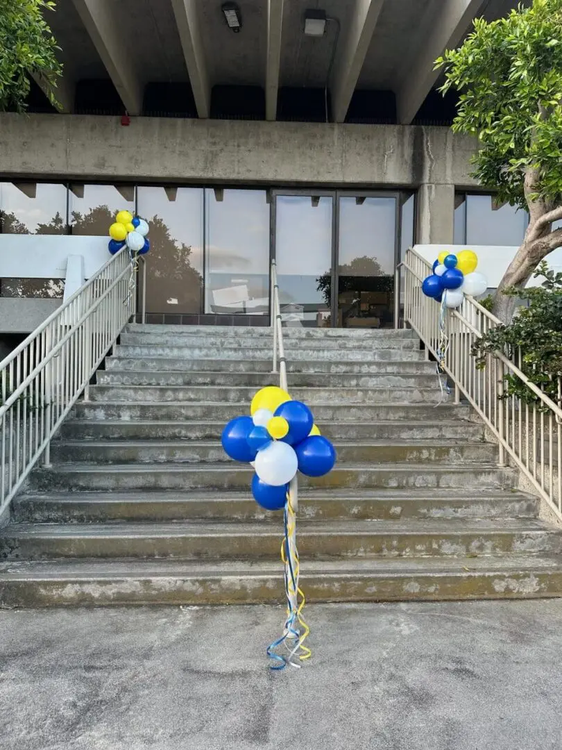 Entrance stairs decorated with blue and yellow balloons