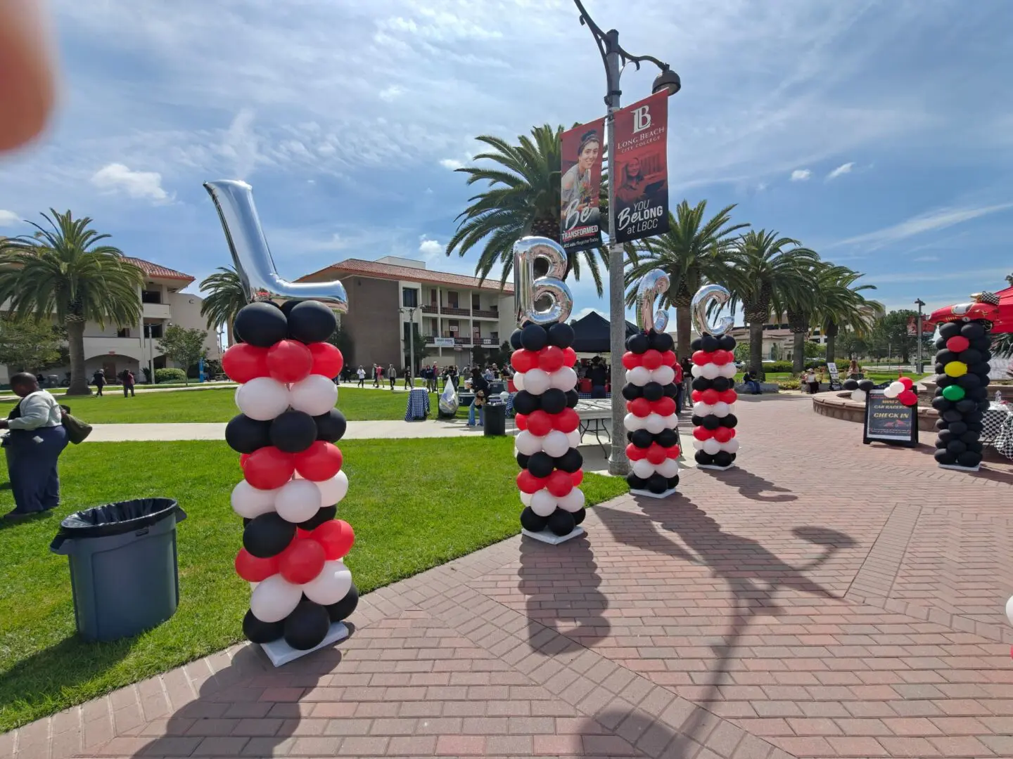 Red black white balloon columns at outdoor plaza