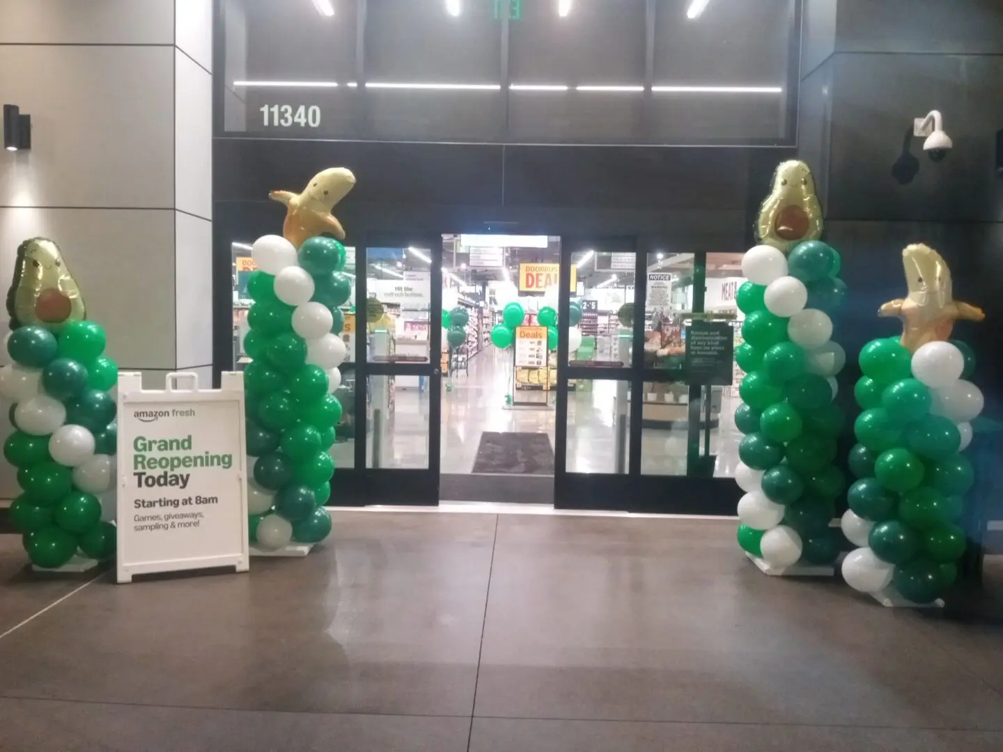 Store entrance with green and white balloon columns