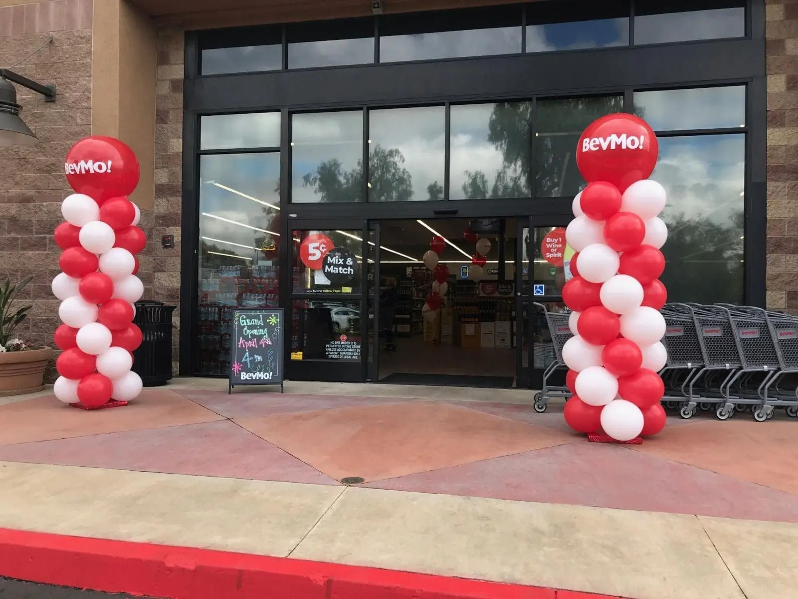 Store entrance with red and white balloon columns