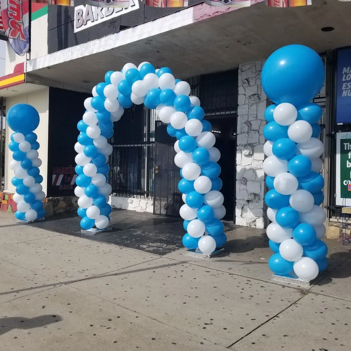 Blue and white balloon arch at entrance