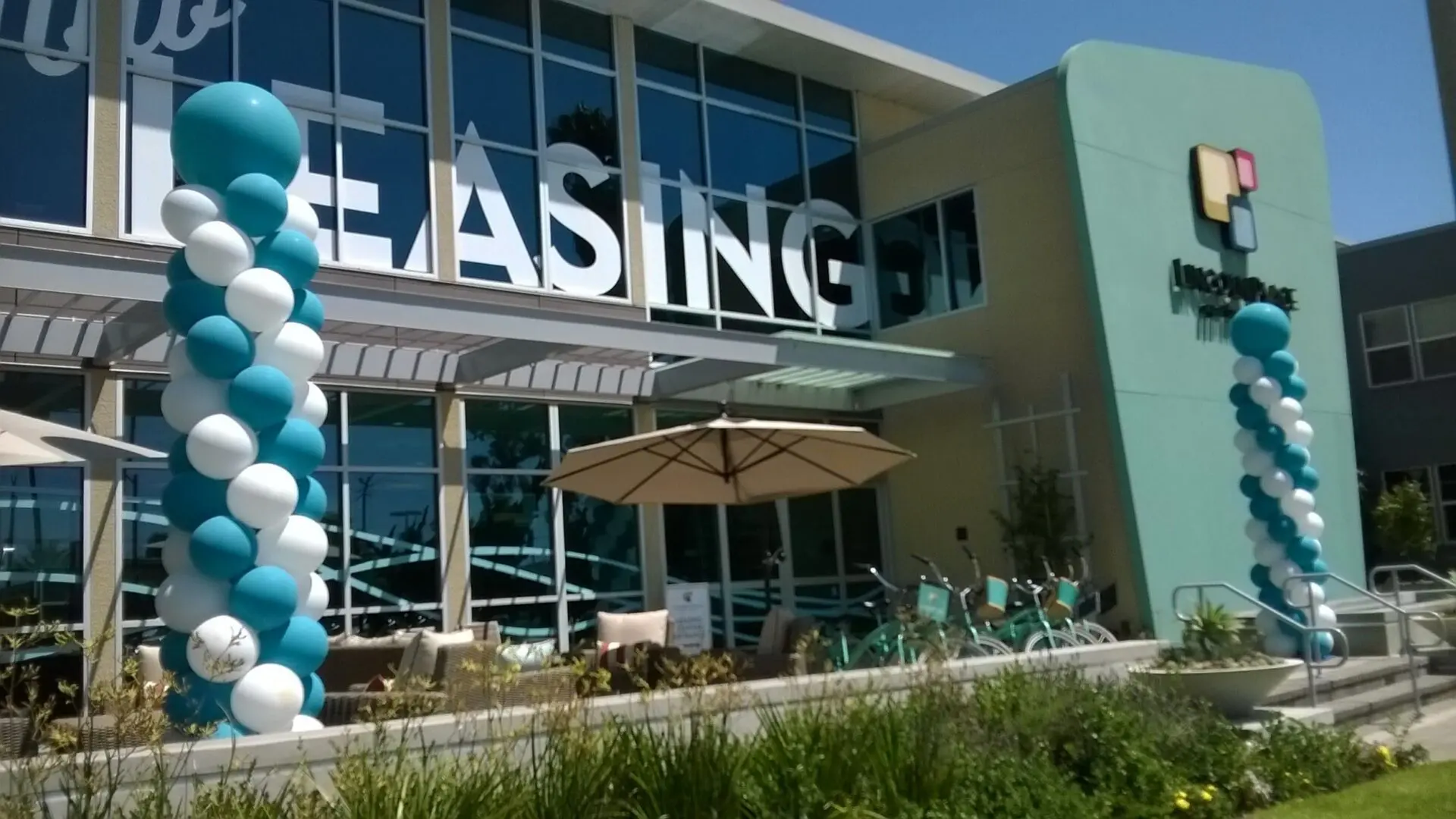 Leasing office entrance decorated with teal balloons