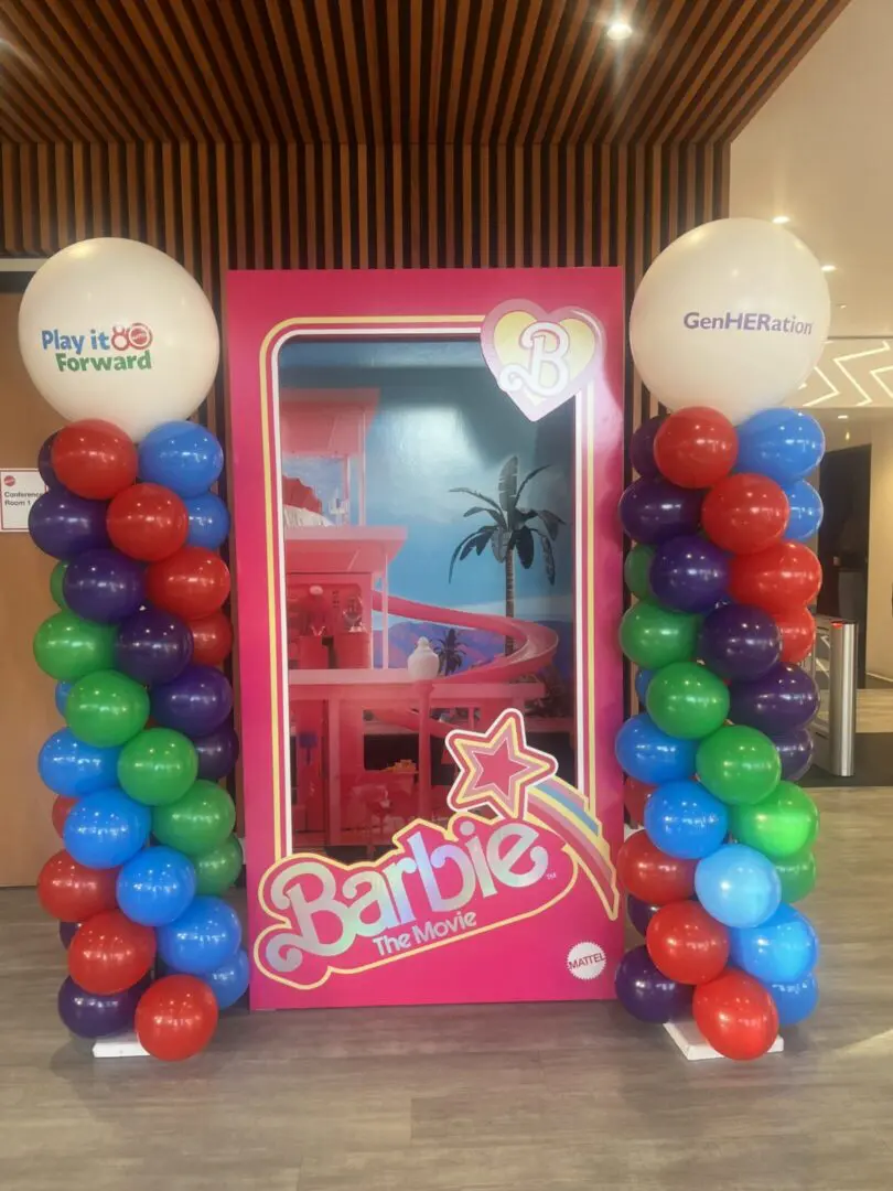 Barbie movie display with colorful balloon columns
