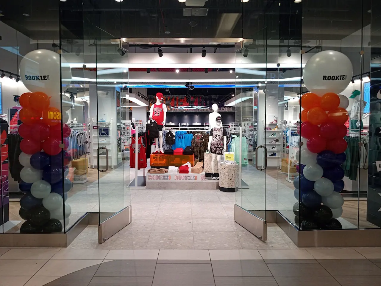 Clothing store entrance with colorful balloon columns