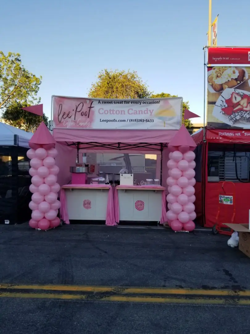 Pink cotton candy stand with balloon columns