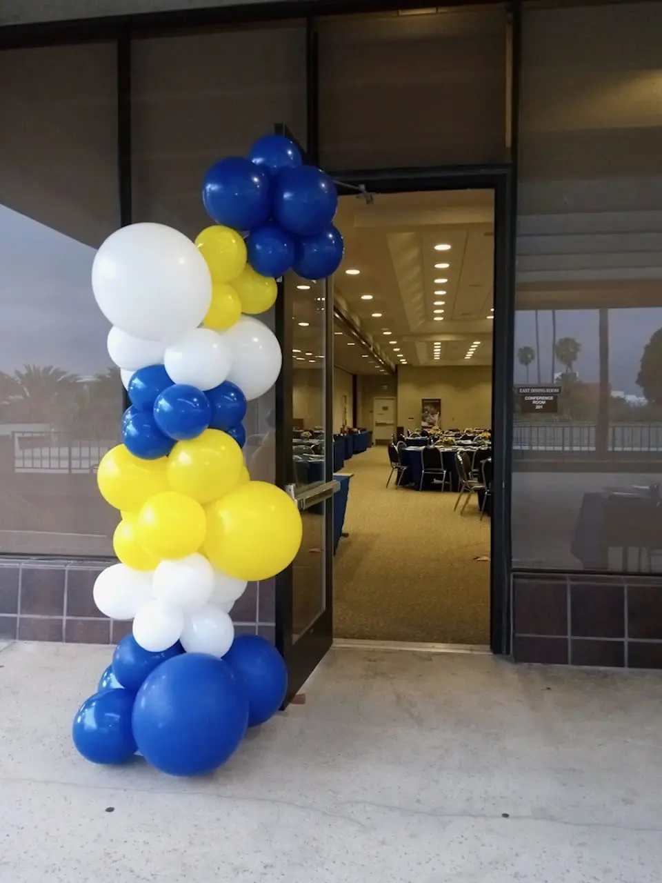Blue, white, yellow balloon column at entrance