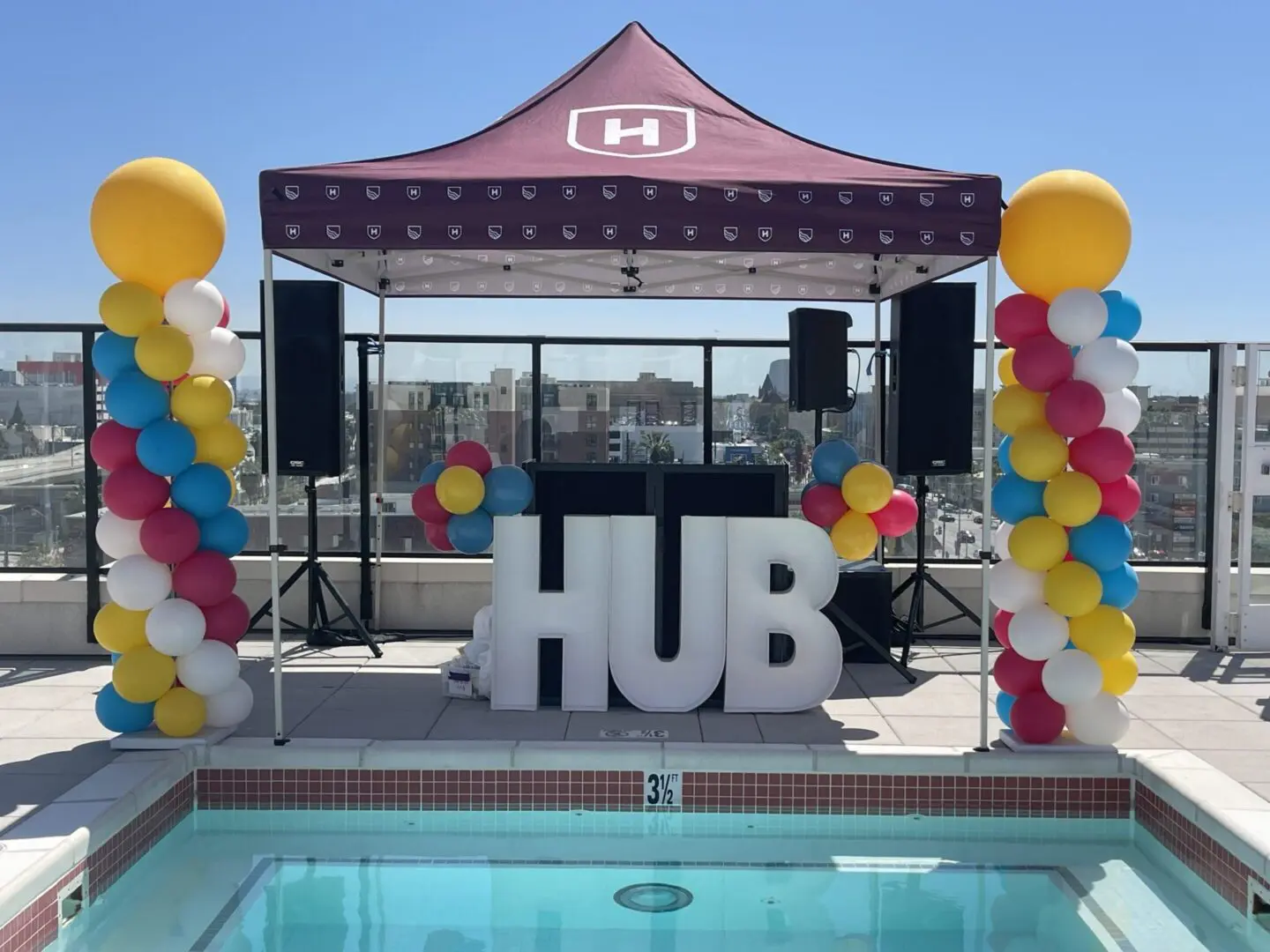 Rooftop pool event tent with HUB letters