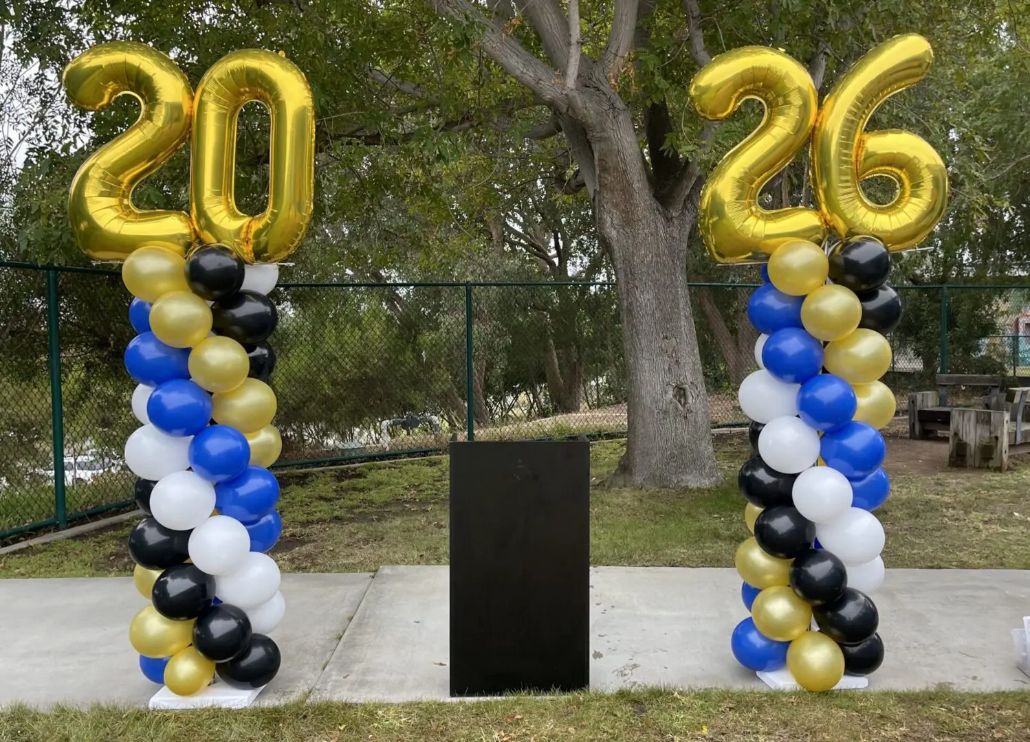 Gold 20 and 26 balloon columns outdoors