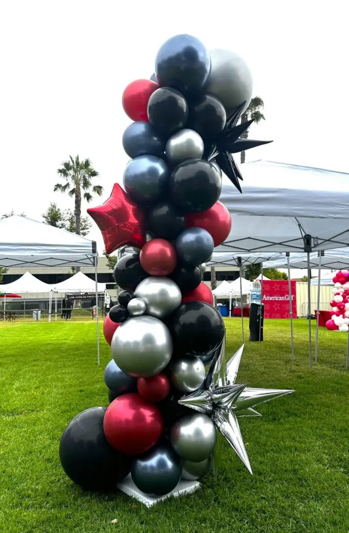 Red, black, and silver balloon column with stars