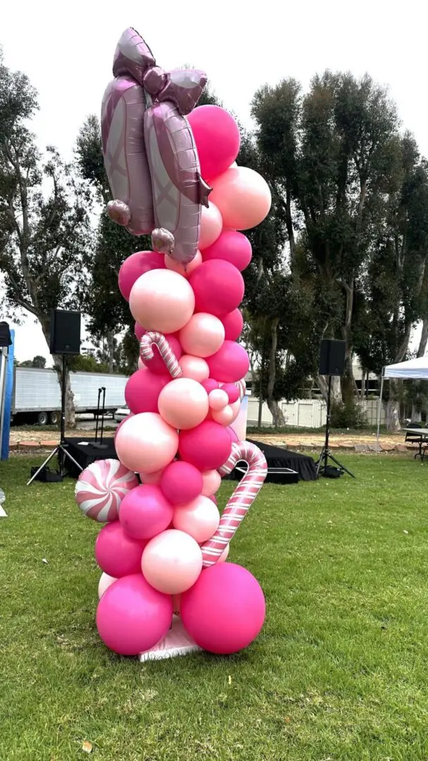Pink balloon column with bow and candy cane