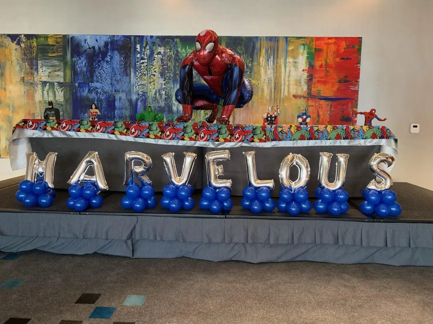 Spider-Man party table with "MARVELOUS" balloons