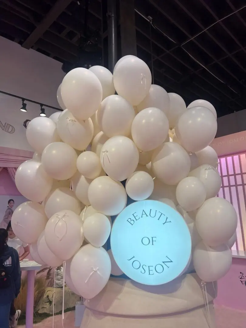 White balloons surrounding Beauty of Joseon sign