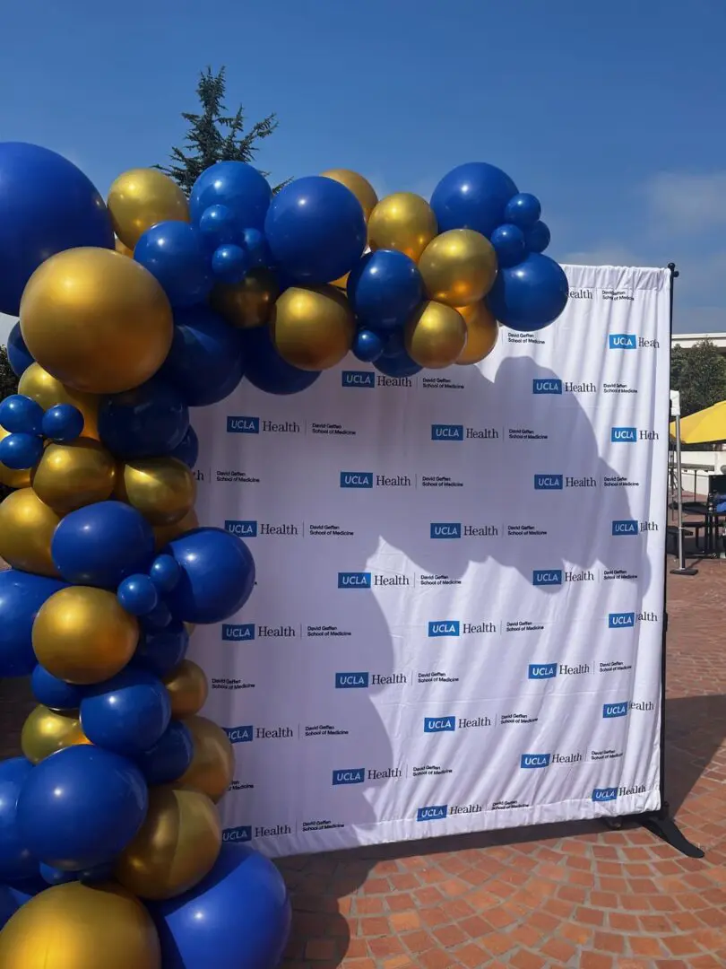 UCLA Health backdrop with blue and gold balloons